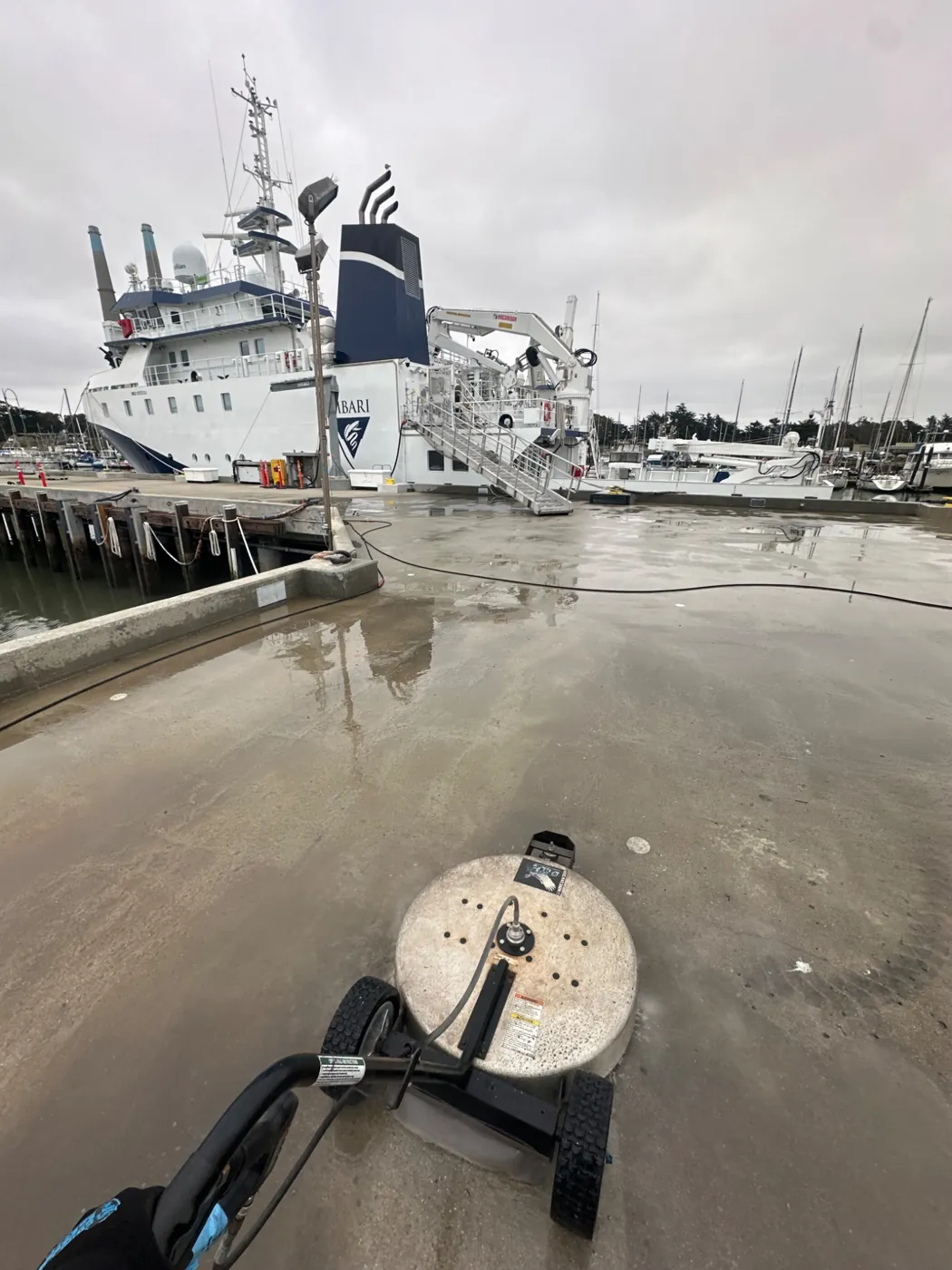 Surface cleaner on a waterfront concrete walkway