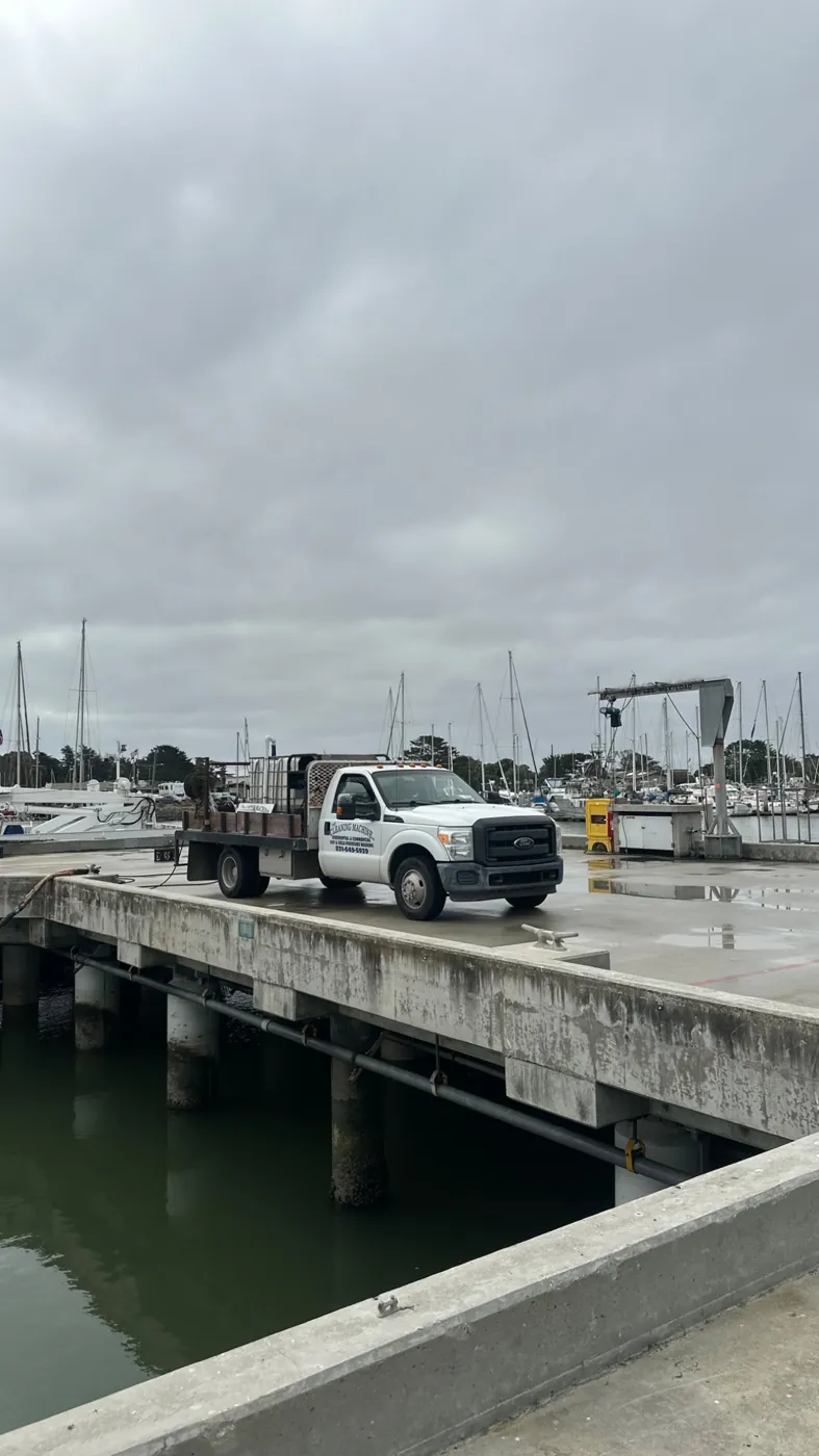 Pressure washing equipment and truck at a waterfront job